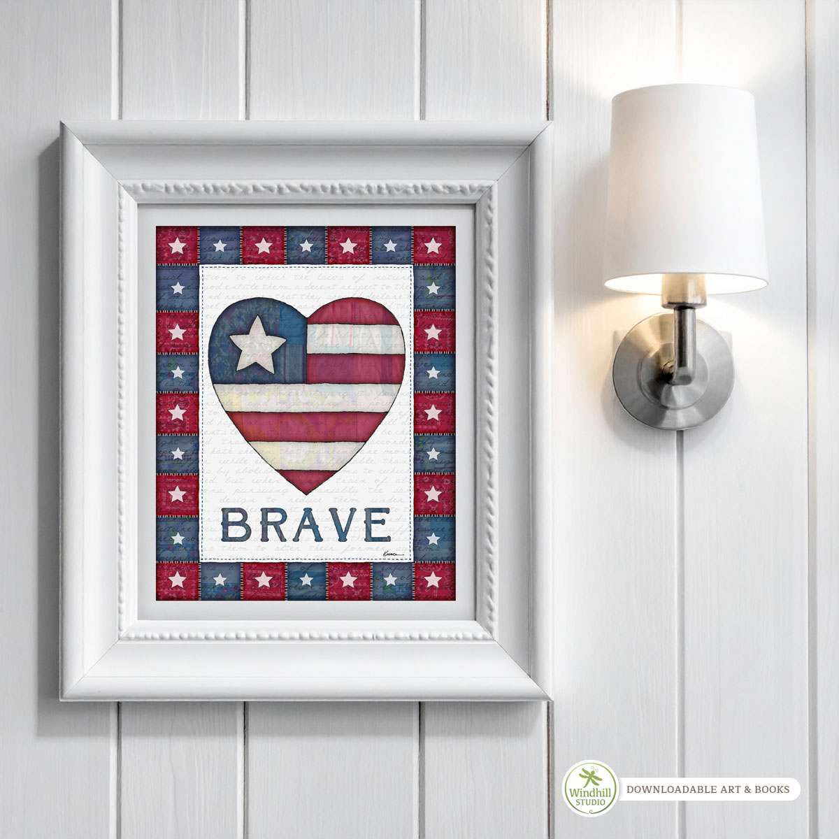 Patriotic Wall Art Printable – BRAVE Americana Heart with quilted stars and red white blue fabric texture hanging in a frame on a wall.