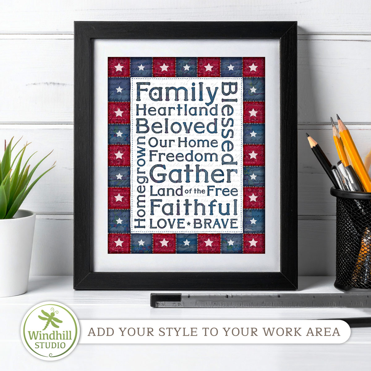 Patriotic Wall Art Printable - Americana Word Art with quilted stars and red white blue fabric texture in a frame on a desk.