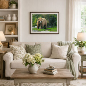 Photograph of a brown bear in a setting of grass and trees framed on a living room wall
