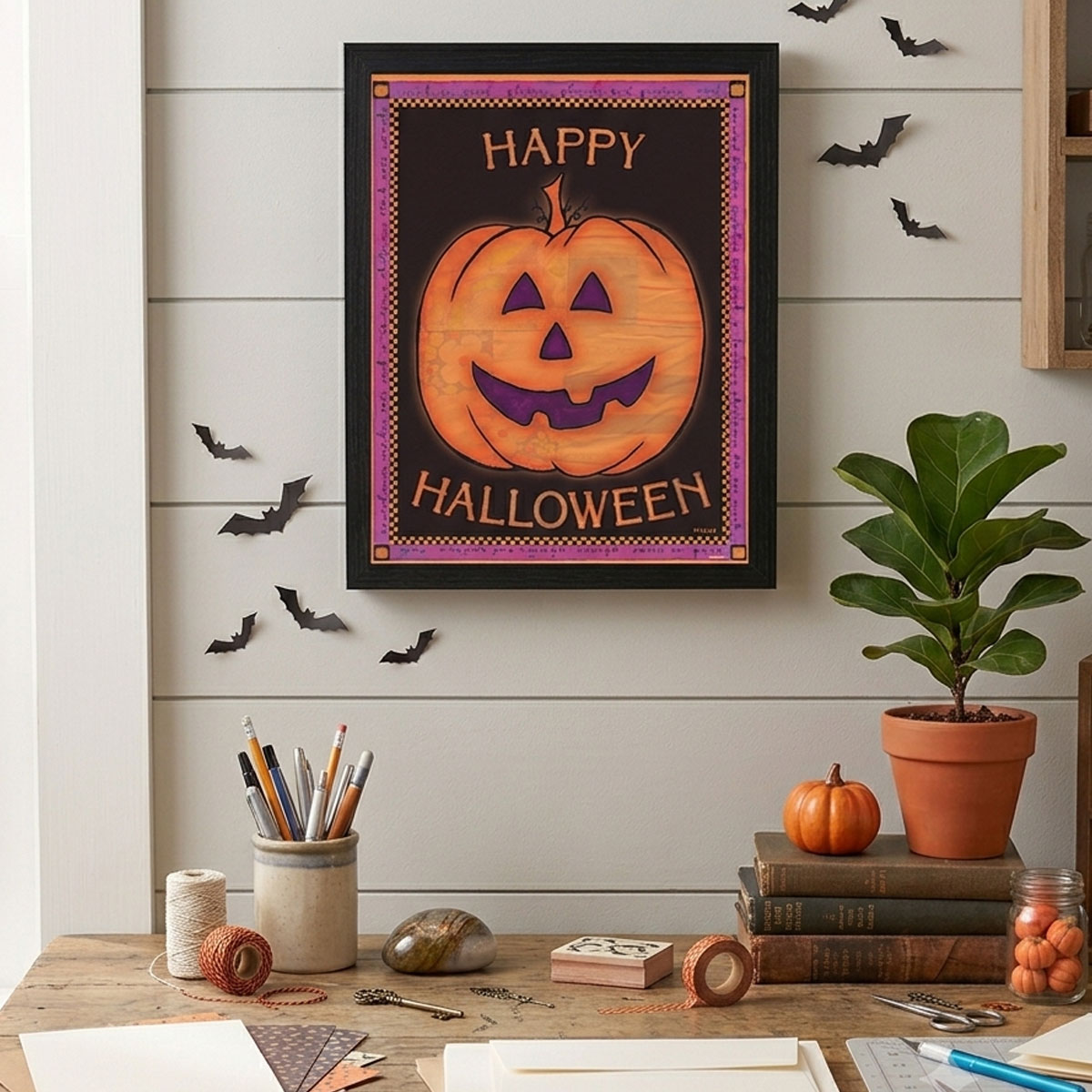 Halloween pumpkin artwork framed on an office wall