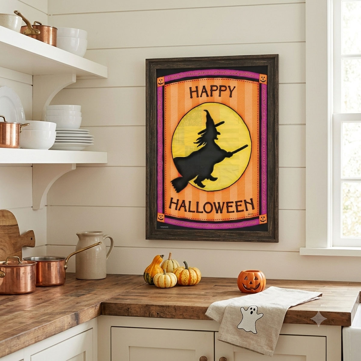 Printable Halloween wall art featuring a folk-art witch silhouette flying past a patchwork moon framed on a kitchen wall