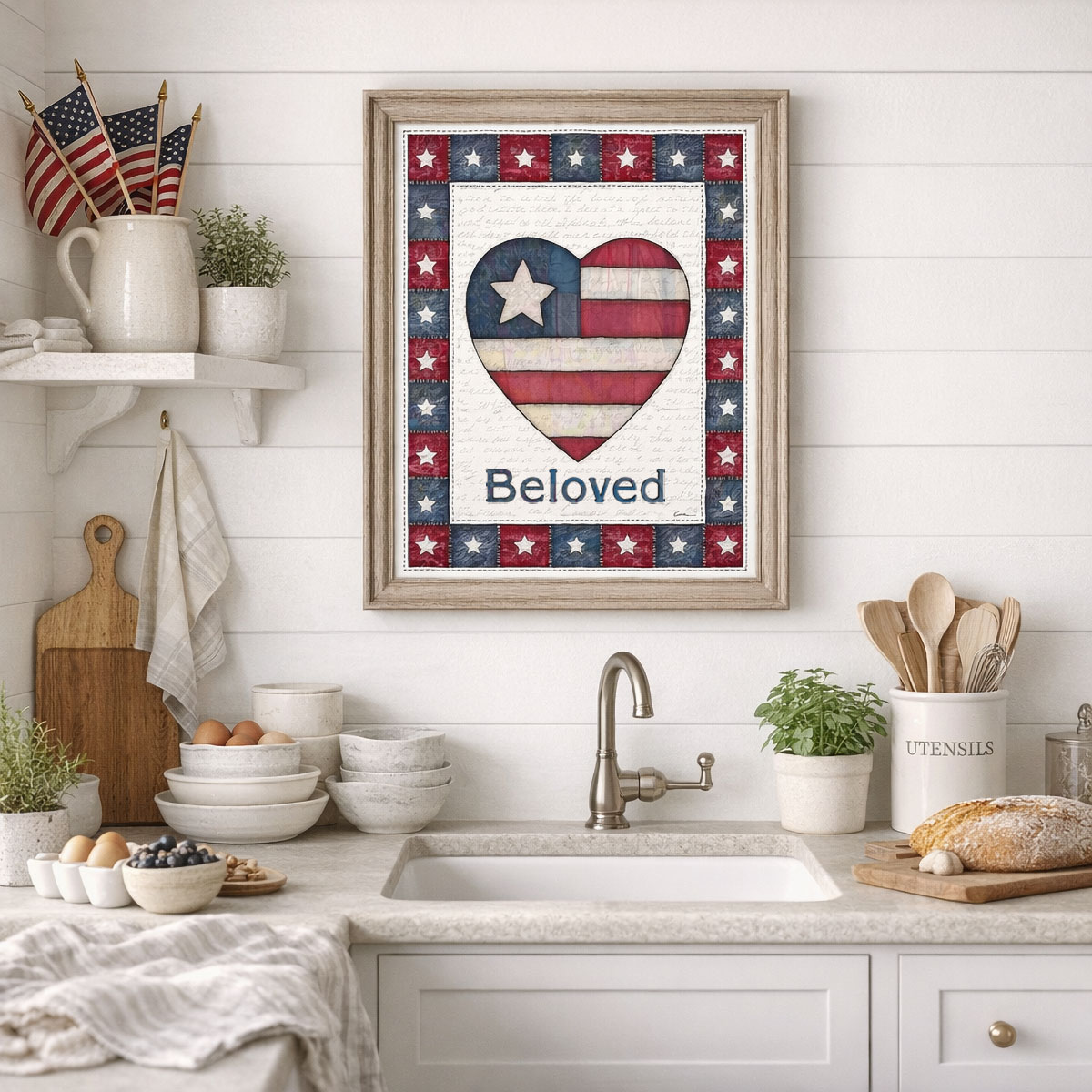 Photo showing a framed print of an American flag graphic inside of a heart with the word Beloved below it.