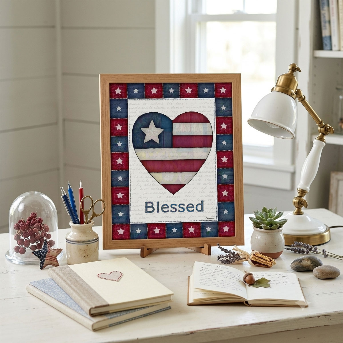 Photo showing a framed print of an American flag graphic inside of a heart with the word Blessed below it.