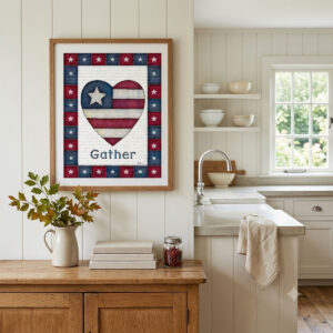 Photo showing a framed print of an American flag graphic inside of a heart with the word Gather below it.