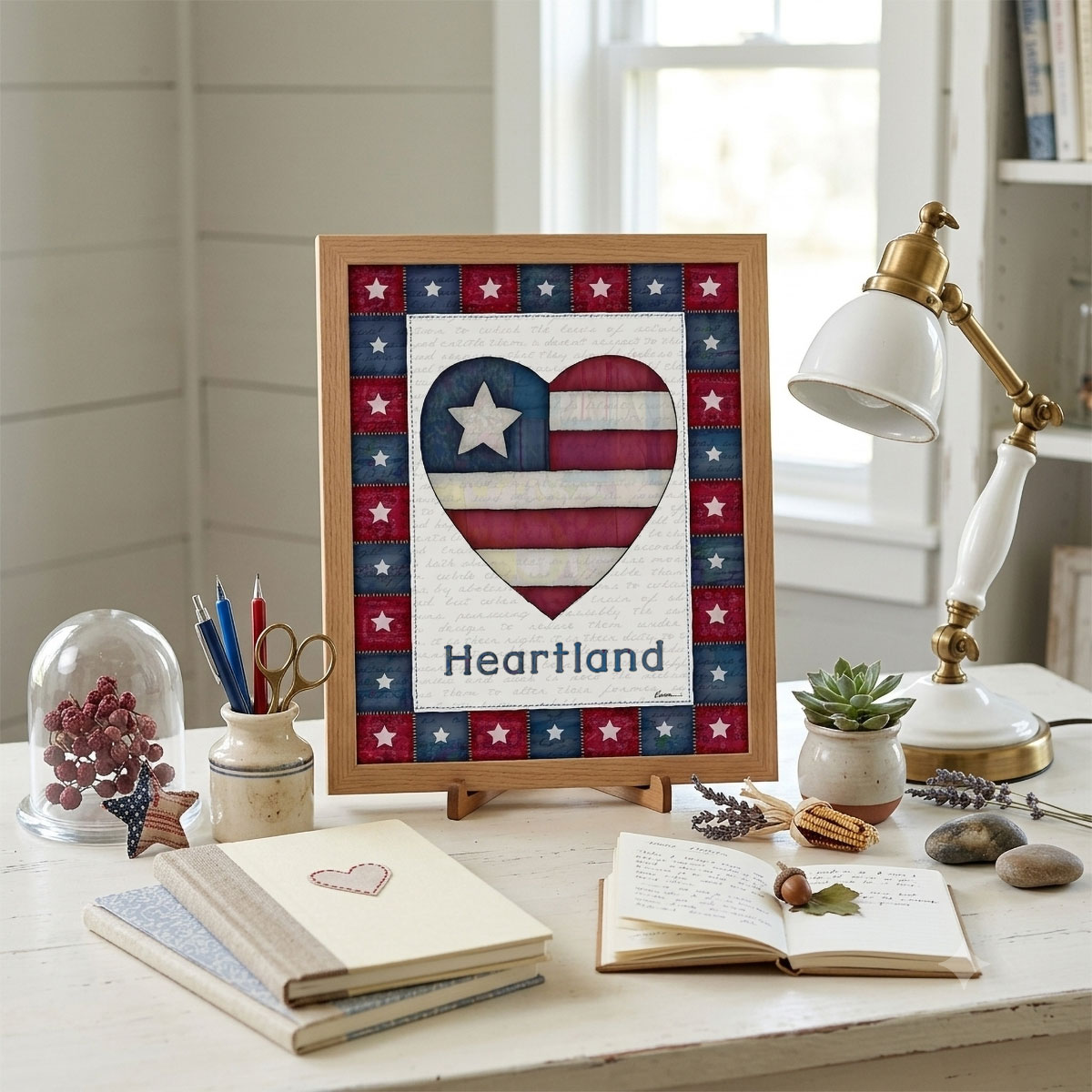 Photo showing a framed print of an American flag graphic inside of a heart with the word Heartland below it.