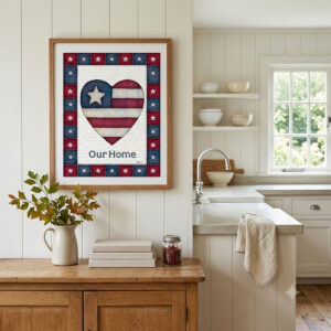 Photo showing a framed print of an American flag graphic inside of a heart with the word Our Home below it.