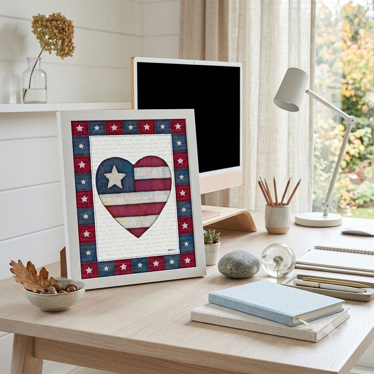 Photo showing a framed print of an American flag graphic inside of a heart.