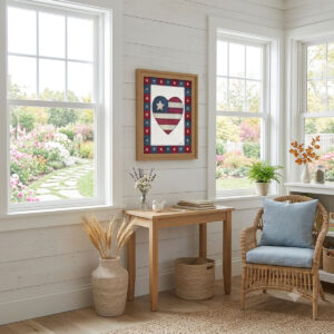 Photo showing a framed print of an American flag graphic inside of a heart.