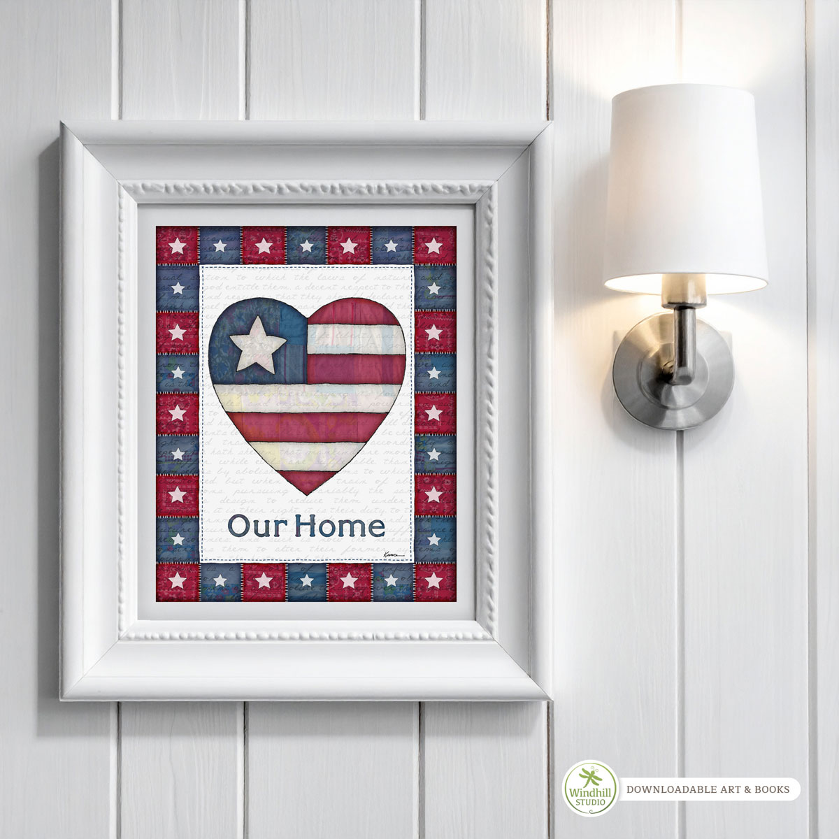 Patriotic Wall Art Printable - Our Home Americana Heart with quilted stars and red white blue fabric texture hanging in a frame on a wall.