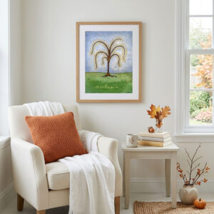 Printable autumn tree wall art featuring a watercolor tree with yellow and orange fall leaves dropping onto a green hill framed in a reading nook